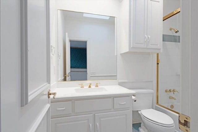 full bathroom featuring vanity, tiled shower / bath combo, and toilet