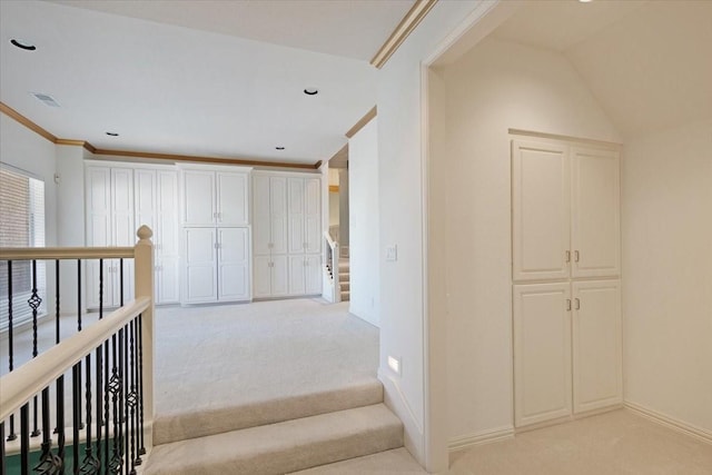 hallway with light carpet and ornamental molding