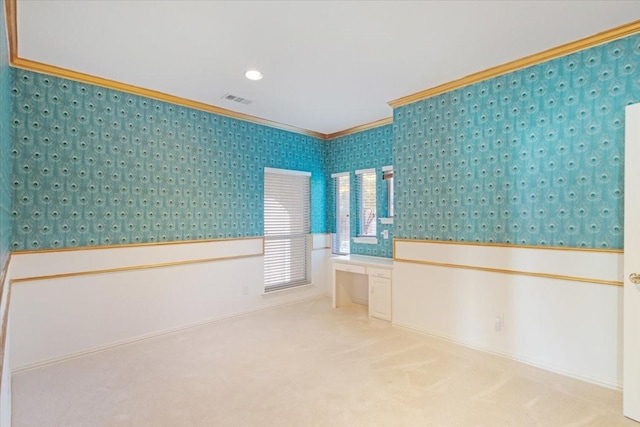 interior space with crown molding and built in desk