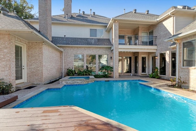 view of pool featuring an in ground hot tub