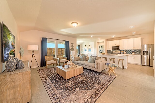 living room featuring light hardwood / wood-style floors and sink