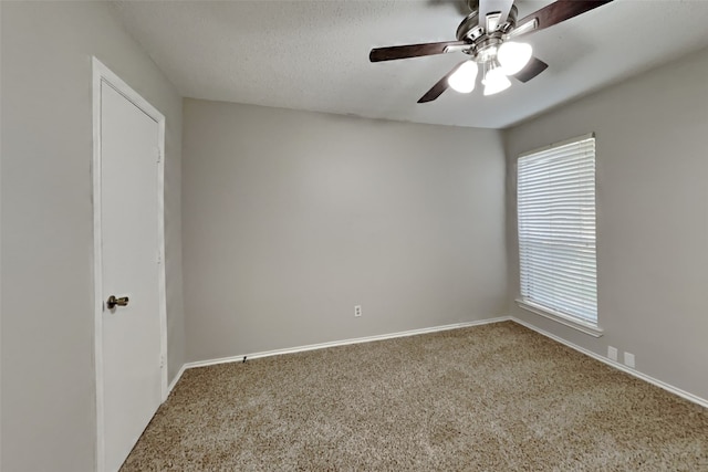 spare room featuring ceiling fan, carpet floors, and a textured ceiling