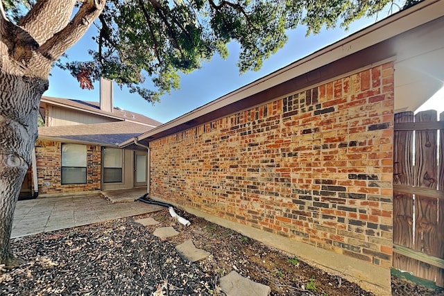 view of side of home with a patio