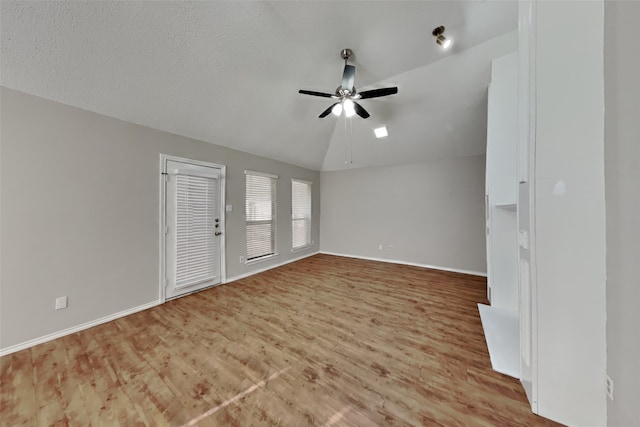 unfurnished living room with lofted ceiling, light hardwood / wood-style flooring, and ceiling fan