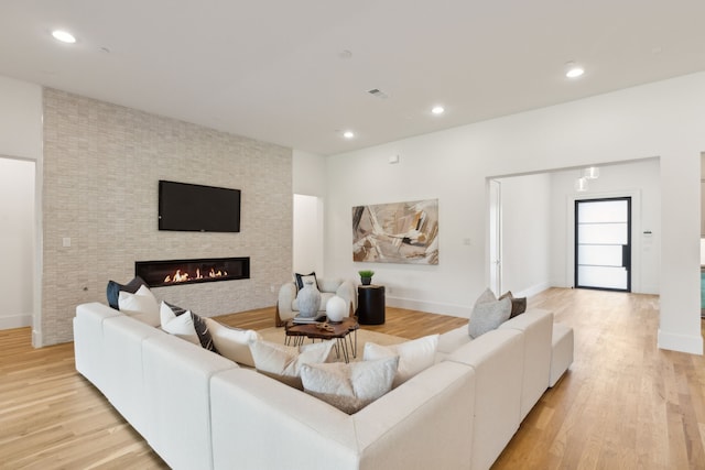 living room with a chandelier and light hardwood / wood-style floors