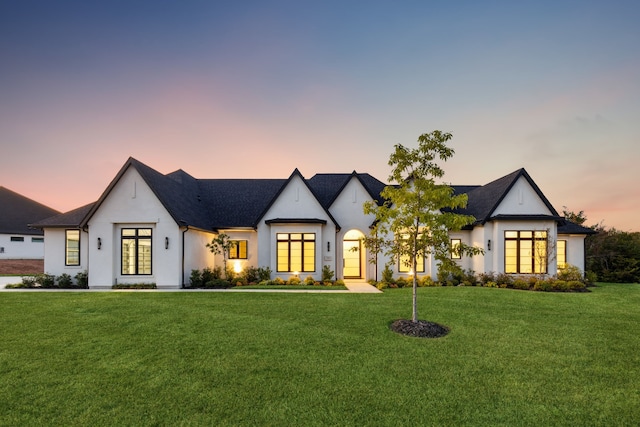 view of front of home featuring central AC unit and a yard