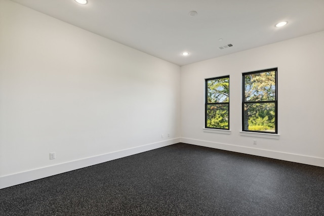 spare room featuring light carpet