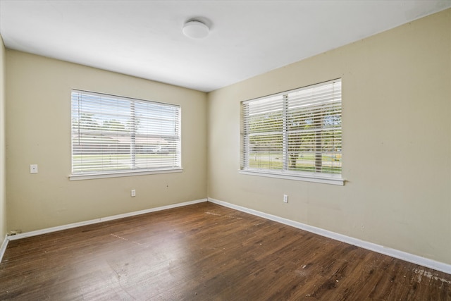 spare room featuring dark hardwood / wood-style flooring