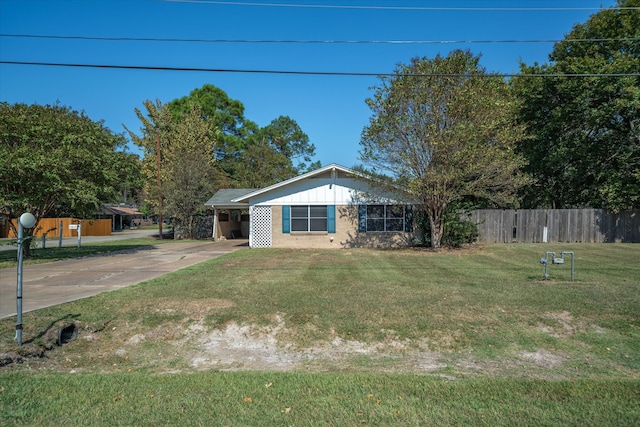 ranch-style home featuring a front yard