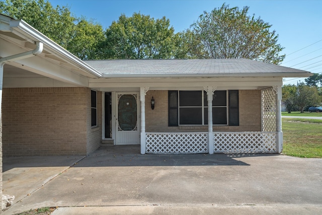 view of exterior entry with a porch