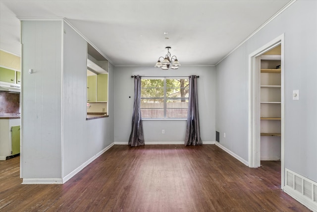 unfurnished dining area with a notable chandelier, crown molding, and dark wood-type flooring