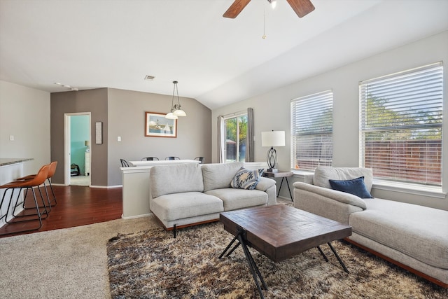 living room with ceiling fan, hardwood / wood-style flooring, a wealth of natural light, and lofted ceiling