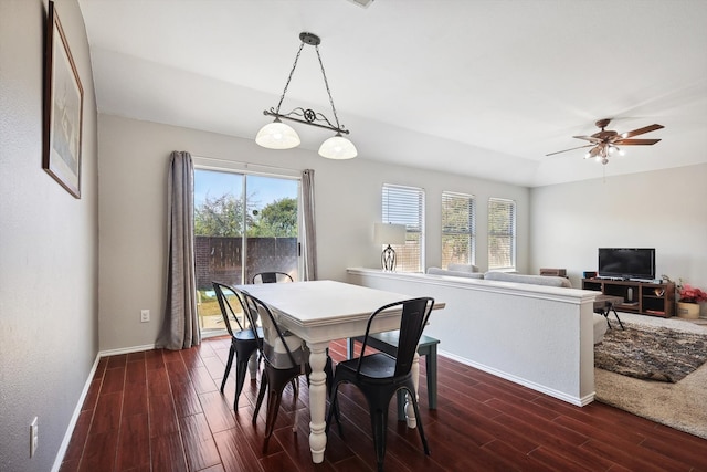 dining space with dark hardwood / wood-style floors and ceiling fan