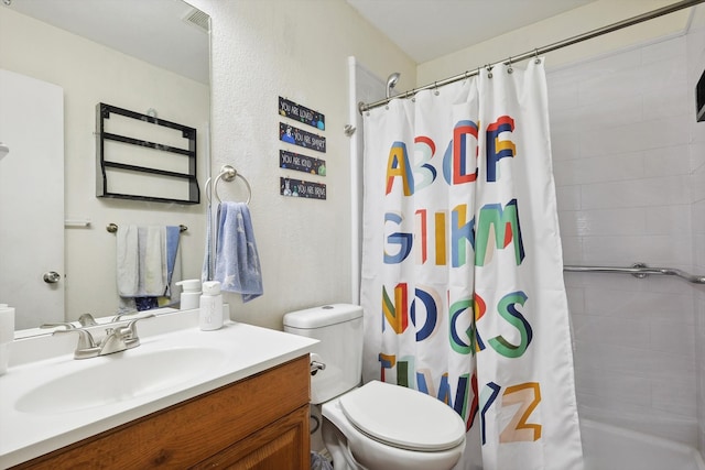 bathroom featuring vanity, toilet, and curtained shower