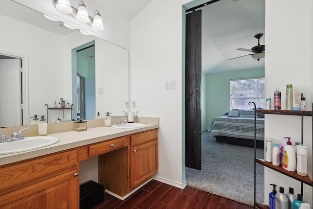 bathroom with hardwood / wood-style flooring, ceiling fan, and vanity