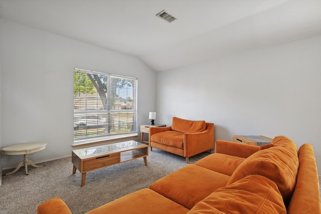 carpeted living room featuring vaulted ceiling