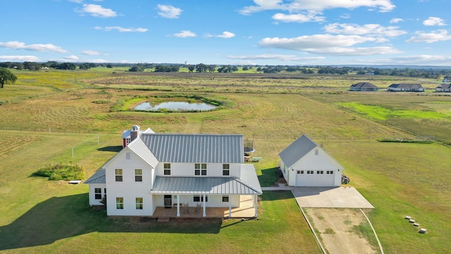 drone / aerial view with a rural view and a water view