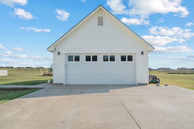 view of home's exterior featuring a garage, a lawn, and an outbuilding