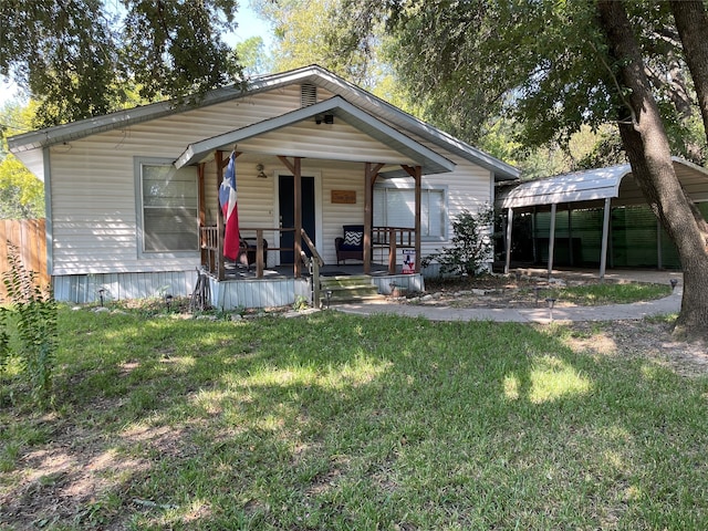 view of front of property featuring a carport, a front yard, and covered porch