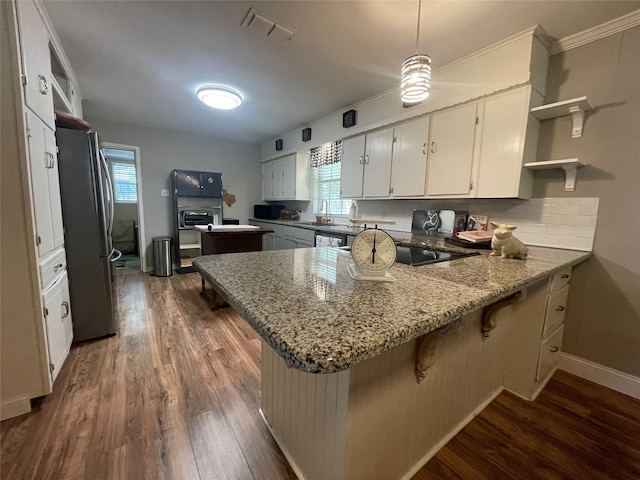 761 S Pacific St, Canton, TX 75103 - kitchen with freestanding refrigerator, open shelves, a peninsula, dark wood-type flooring, and healthy amount of natural light