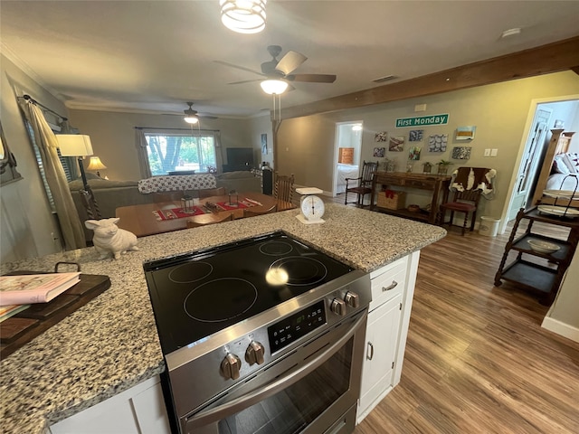 kitchen featuring white cabinetry, stainless steel range with electric stovetop, crown molding, light stone counters, and light hardwood / wood-style flooring