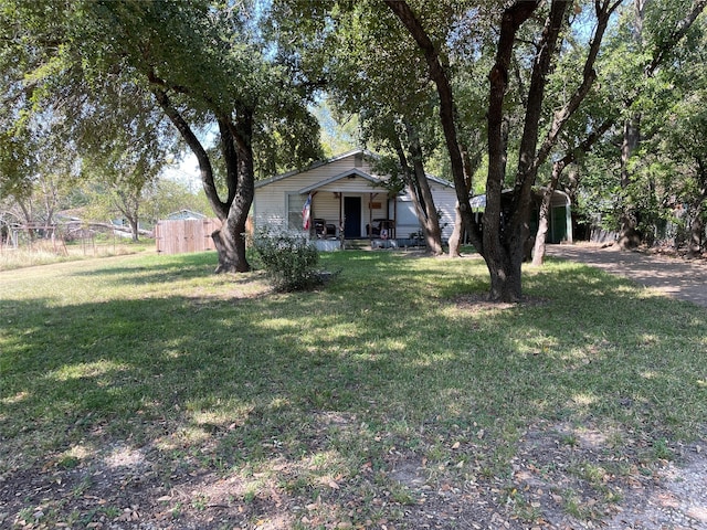 view of yard featuring a storage shed and covered porch