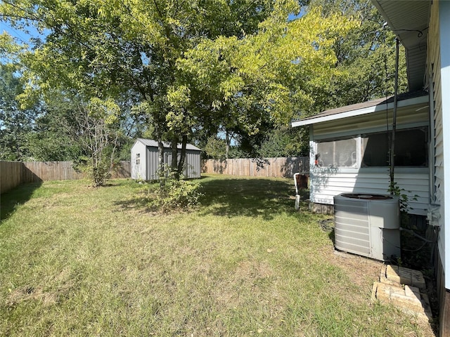 view of yard featuring central AC and a storage shed