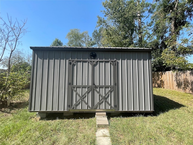 view of outbuilding with a yard