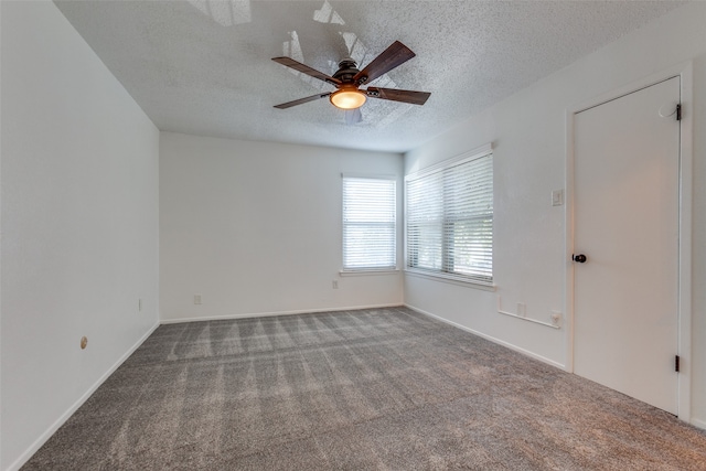 spare room featuring a textured ceiling, ceiling fan, and carpet