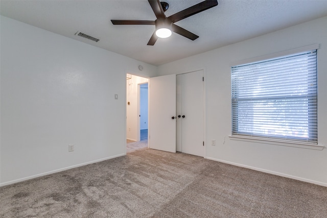 unfurnished room featuring ceiling fan and light colored carpet