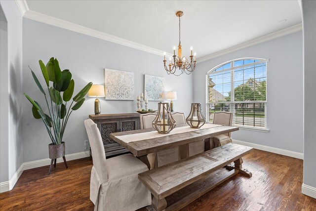 dining area featuring crown molding, dark hardwood / wood-style flooring, and an inviting chandelier