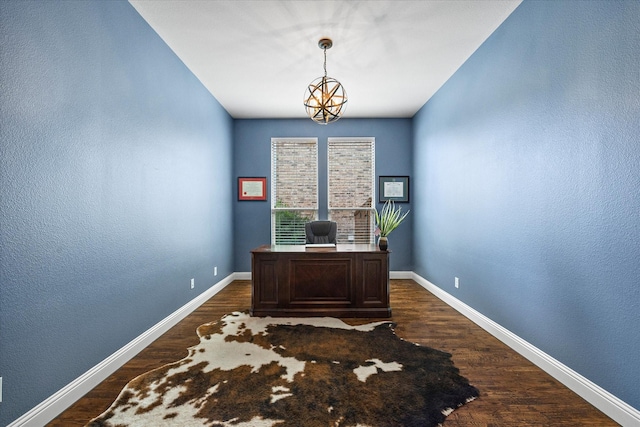 home office featuring dark hardwood / wood-style flooring and an inviting chandelier