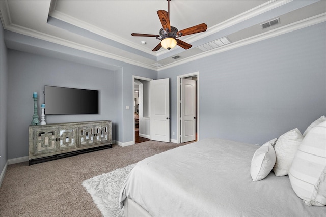 carpeted bedroom featuring a raised ceiling, ceiling fan, and crown molding