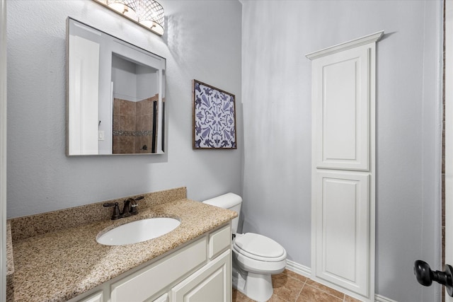 bathroom with tile patterned floors, vanity, and toilet