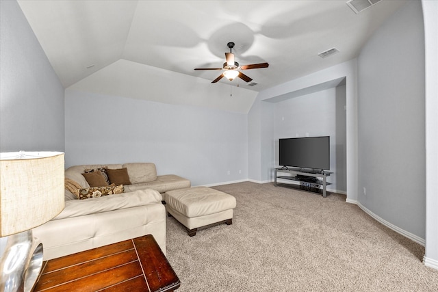 carpeted living room with ceiling fan and vaulted ceiling