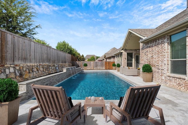 view of pool featuring pool water feature and a patio area