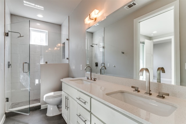 bathroom with tile patterned flooring, vanity, walk in shower, and toilet