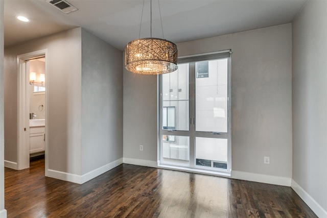 empty room with dark hardwood / wood-style flooring