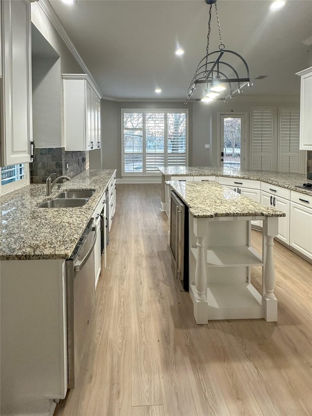 kitchen with white cabinetry, a center island, pendant lighting, and decorative backsplash