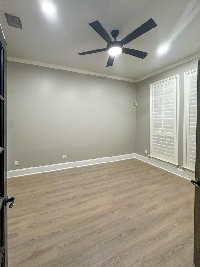 unfurnished bedroom featuring crown molding, light wood-type flooring, ceiling fan, and french doors