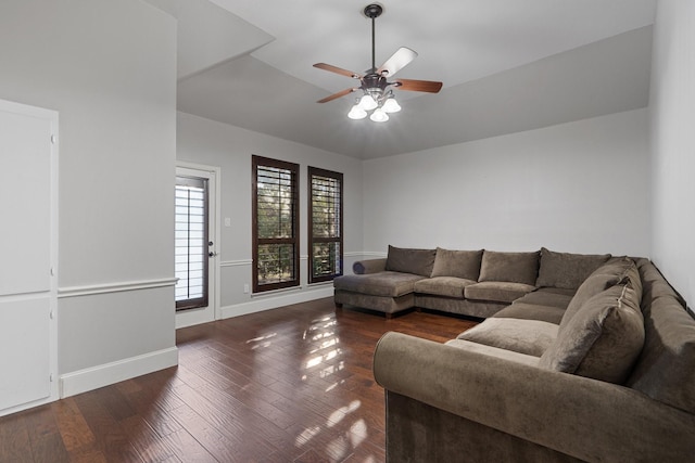 living room featuring ceiling fan and dark hardwood / wood-style floors