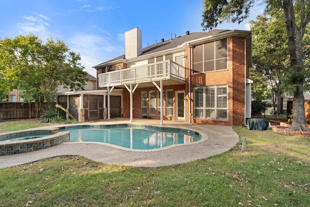 rear view of property featuring brick siding, a chimney, fence, and a sunroom