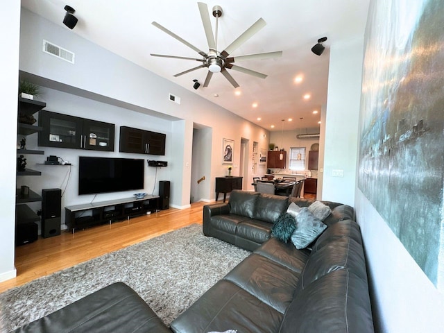 living room with ceiling fan and hardwood / wood-style flooring