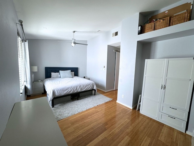 bedroom featuring high vaulted ceiling and hardwood / wood-style flooring