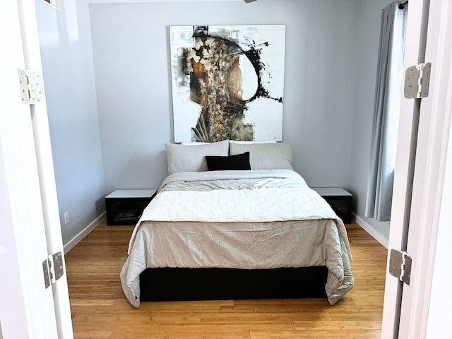 bedroom with wood-type flooring