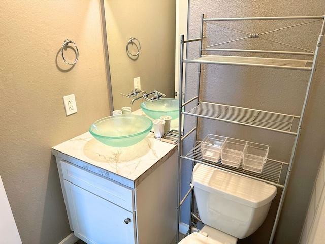 bathroom featuring toilet and vanity