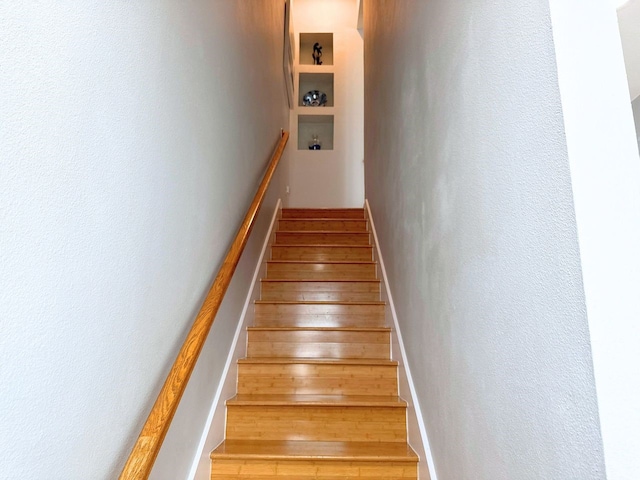 stairs featuring hardwood / wood-style flooring