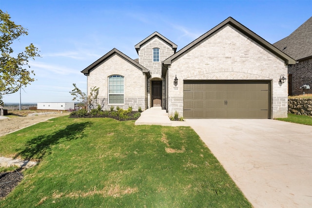 french country inspired facade featuring a front yard and a garage