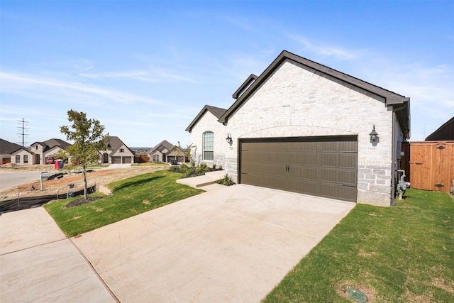 view of front of property with a front yard and a garage