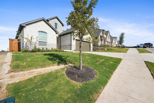 view of front of property with a front yard and a garage